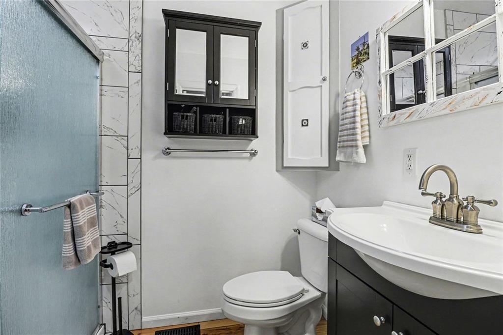 387 Ruby Lane Mineral Bluff, GA 30559 - Photo 16 of 29 a bathroom with a toilet sink and mirror