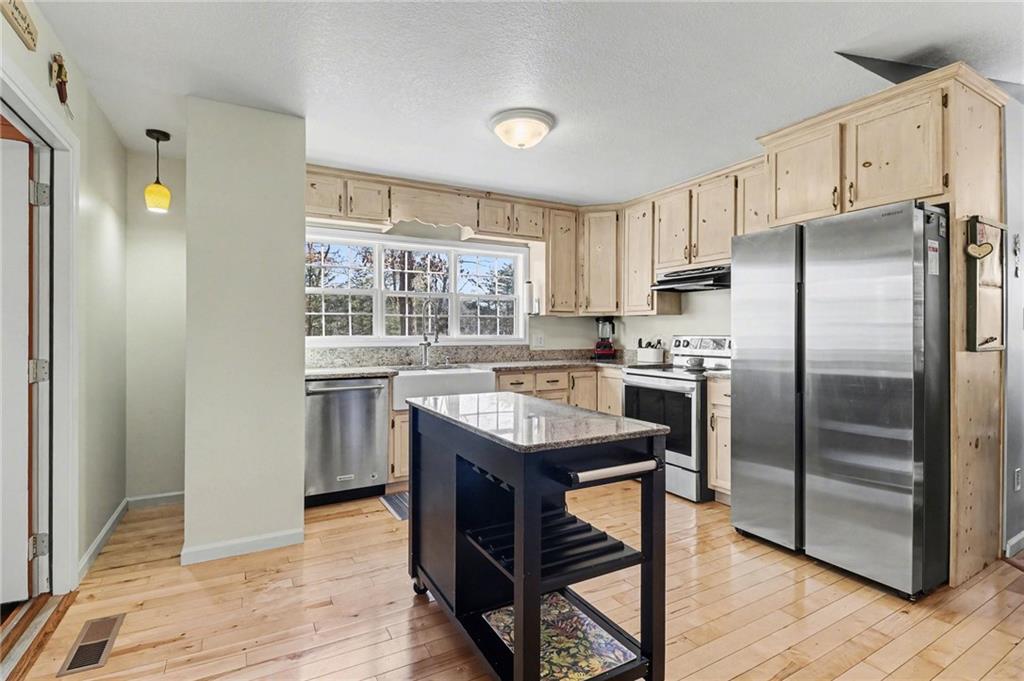 387 Ruby Lane Mineral Bluff, GA 30559 - Photo 7 of 29 a kitchen with kitchen island a counter top space a sink appliances and cabinets