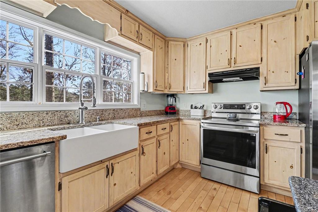 387 Ruby Lane Mineral Bluff, GA 30559 - Photo 8 of 29 a kitchen with stainless steel appliances granite countertop a stove a sink and a microwave