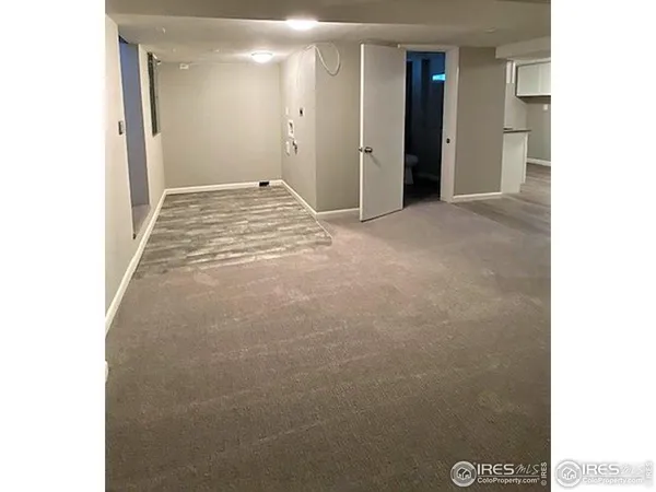 a view of a closet with wooden floor