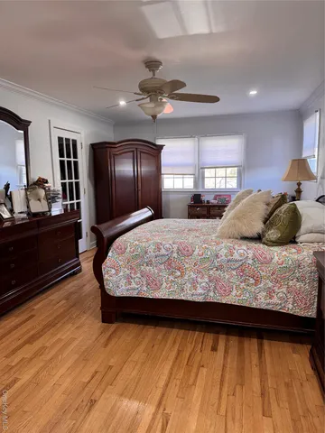 a bed sitting in a bedroom next to a window with dresser