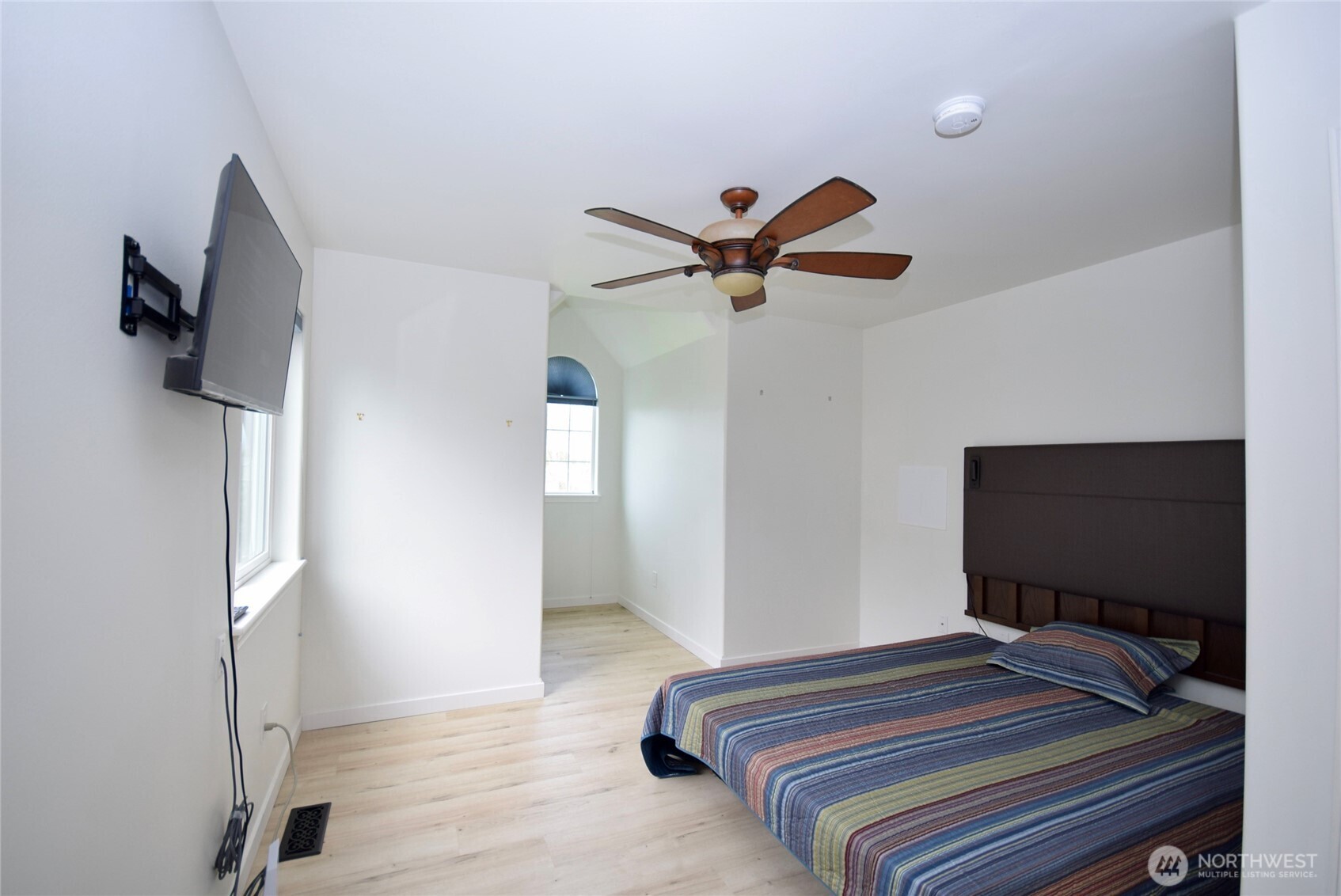 71 John Carl Road Sequim, WA 98382 - Photo 29 of 37 a bedroom with a bed and a flat screen tv