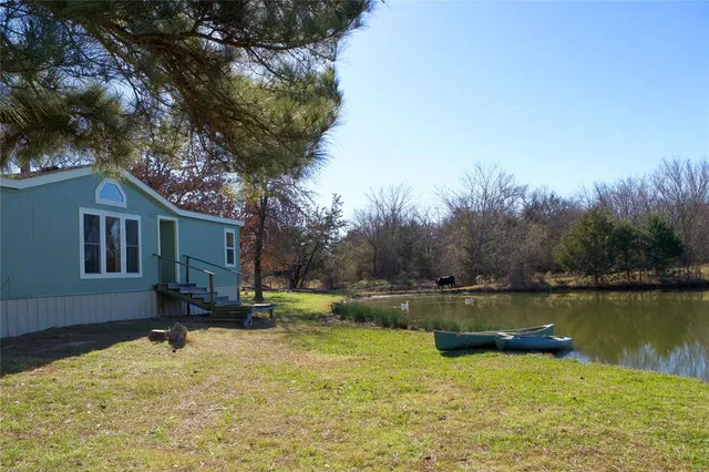 a view of a lake with a house in the background