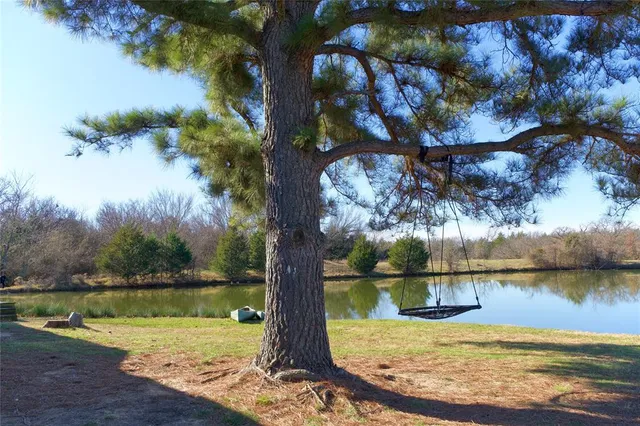 a view of a lake with houses in the back
