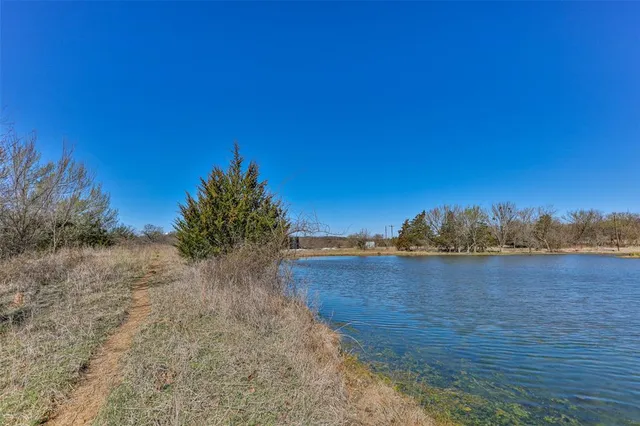 a view of a lake with trees in the background