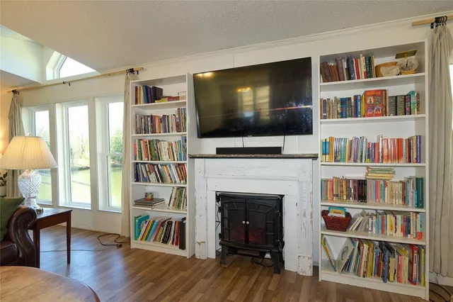 a living room with fireplace and a flat screen tv