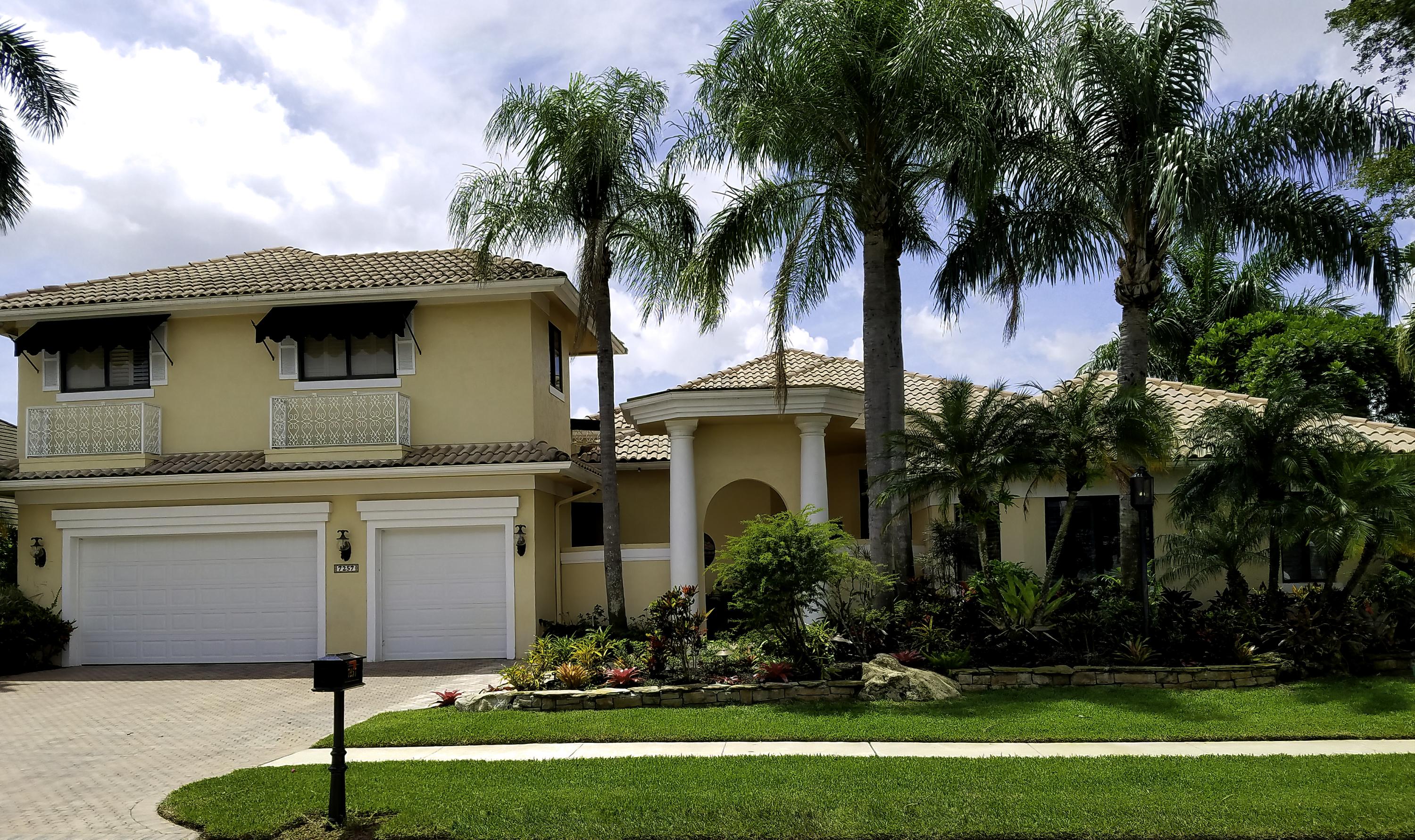 7257 Mandarin Drive Boca Raton, FL 33433 - Photo 1 of 35 a front view of a house with a yard and palm trees