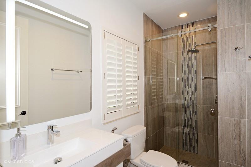 7257 Mandarin Drive Boca Raton, FL 33433 - Photo 13 of 35 a bathroom with a shower a sink and a toilet