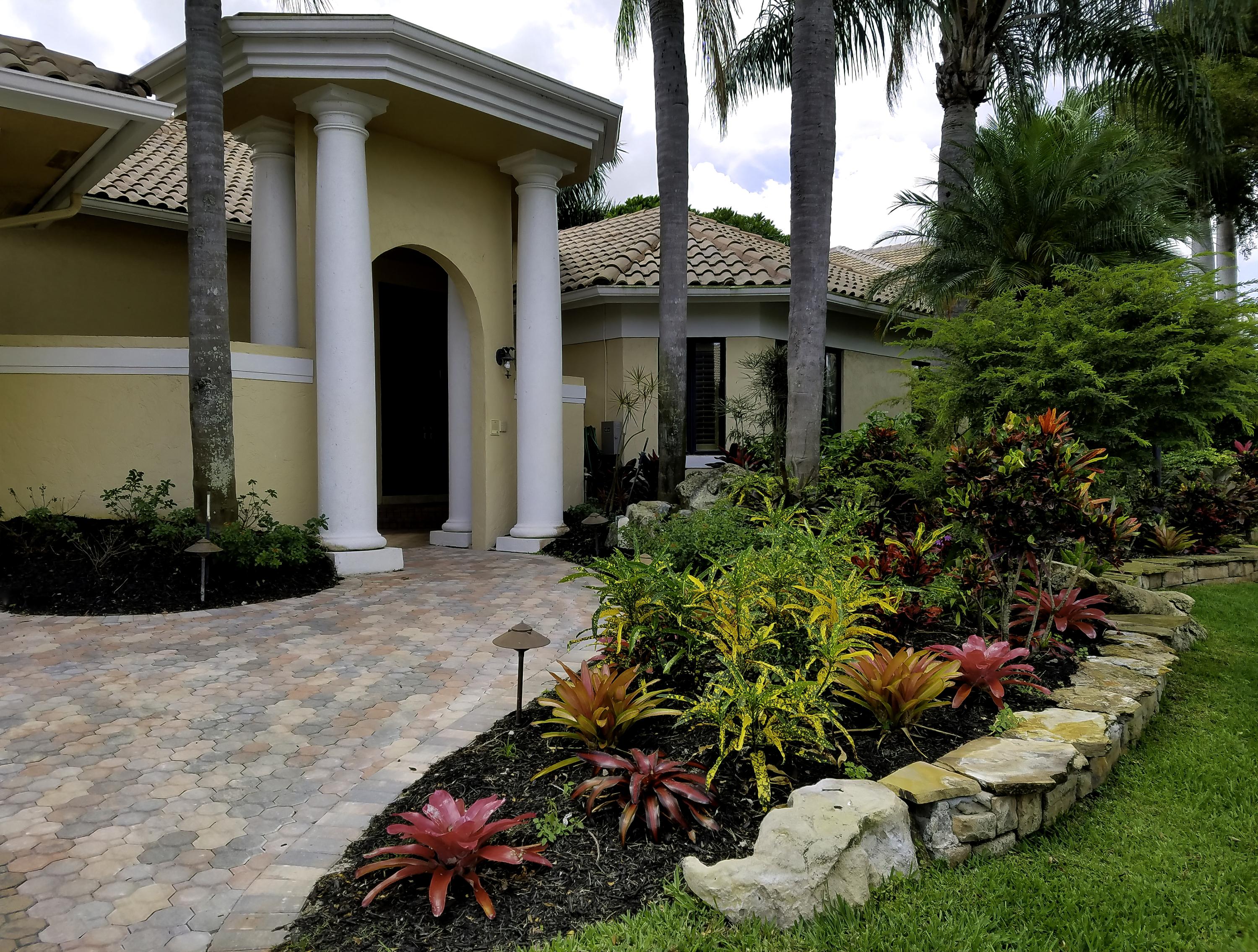7257 Mandarin Drive Boca Raton, FL 33433 - Photo 2 of 35 a front view of a house with a yard