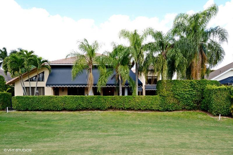7257 Mandarin Drive Boca Raton, FL 33433 - Photo 24 of 35 a front view of a house with a garden