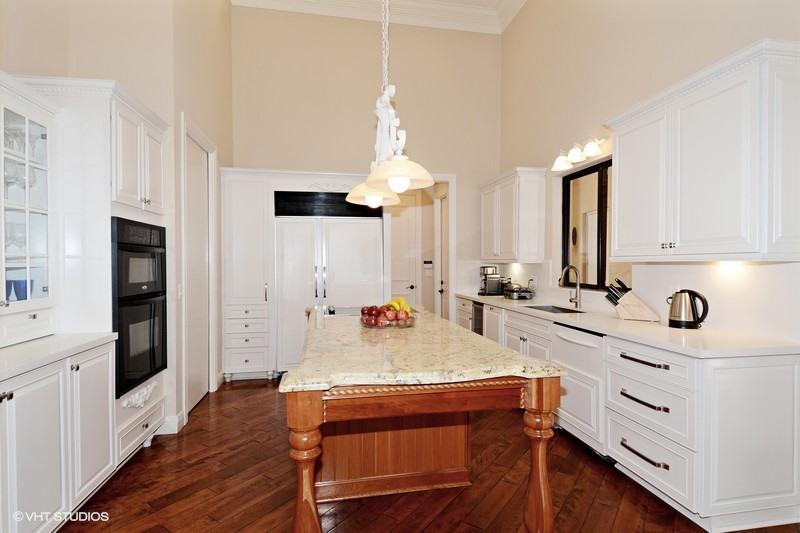 7257 Mandarin Drive Boca Raton, FL 33433 - Photo 5 of 35 a large kitchen with kitchen island a stove a sink a dining table and chairs
