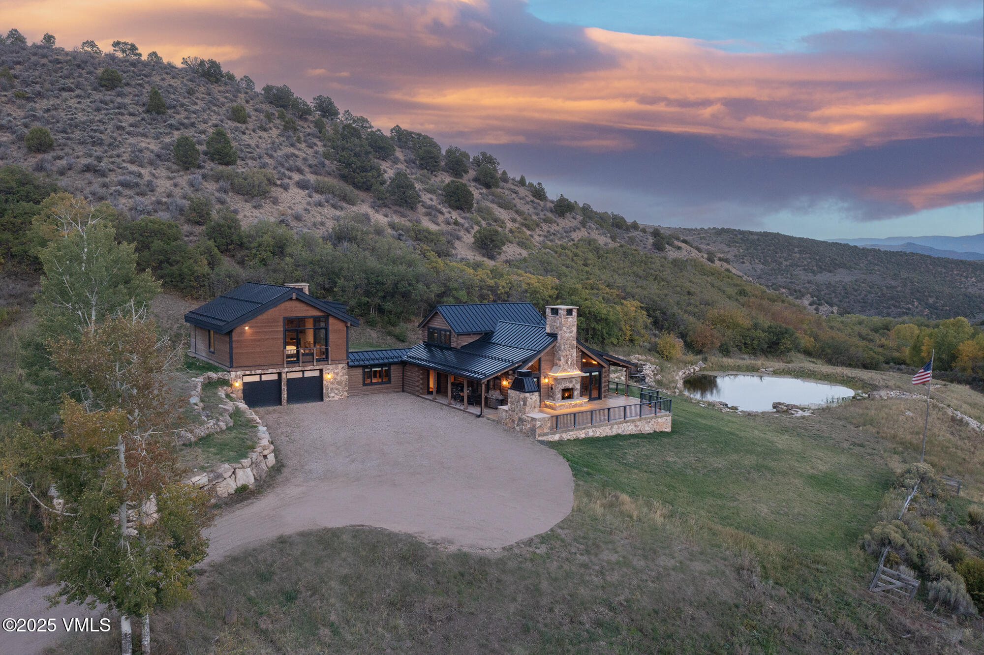 an aerial view of a house with a yard basket ball court and outdoor seating