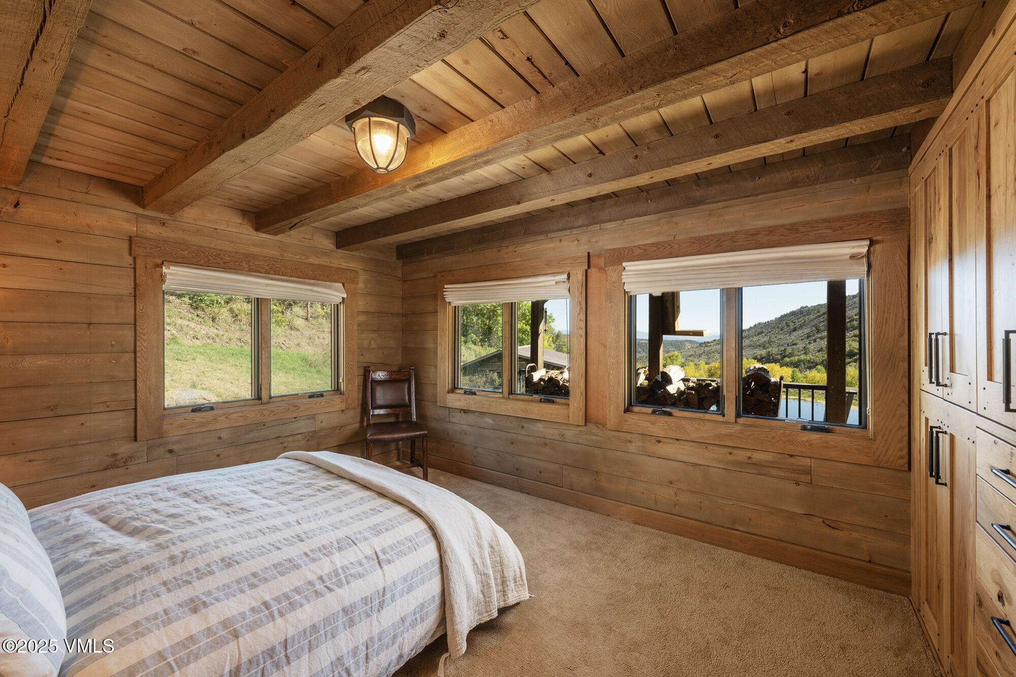 1500 West Sheep Creek Road Gypsum, CO 81637 - Photo 22 of 48 a large bedroom with a large bed and large windows