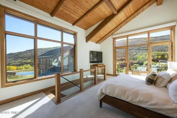 a spacious bedroom with two beds and a chandelier