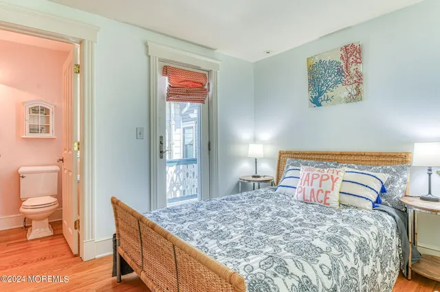 a bedroom with a bed and a dresser with mirror