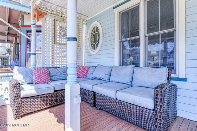 a outdoor living room with furniture and a large window