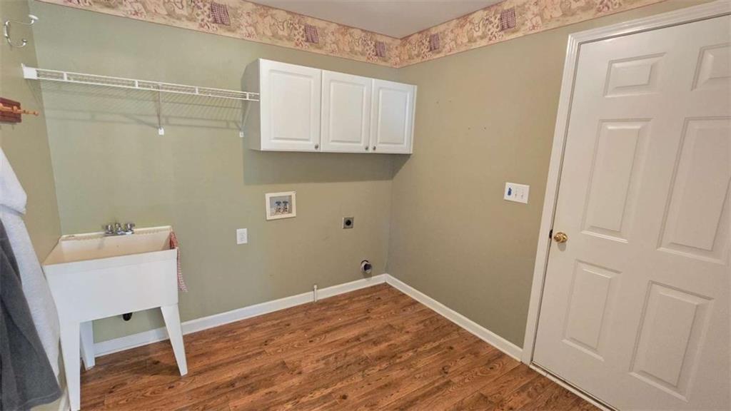 352 Olde Wick Trail Hoschton, GA 30548 - Photo 14 of 34 a room with cabinets and wooden floor