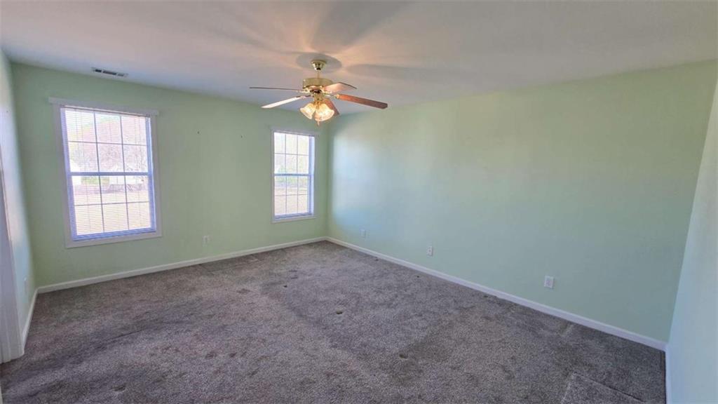 352 Olde Wick Trail Hoschton, GA 30548 - Photo 16 of 34 an empty room with a window and a chandelier fan