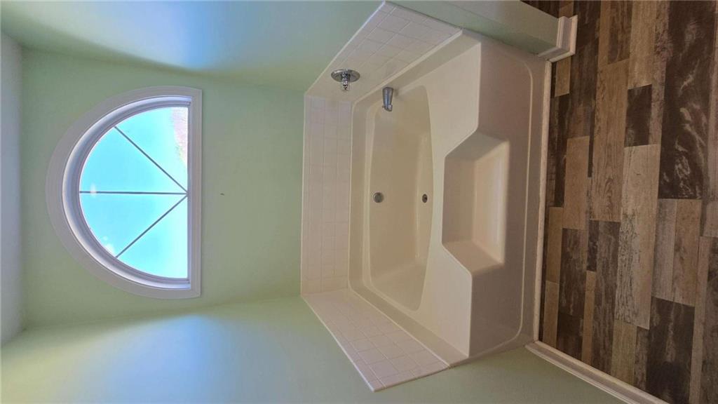 352 Olde Wick Trail Hoschton, GA 30548 - Photo 19 of 34 a bathroom with a bathtub and a sink