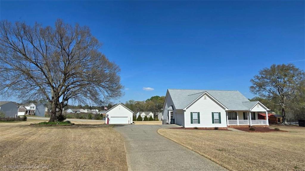 352 Olde Wick Trail Hoschton, GA 30548 - Photo 2 of 34 a view of a large house with a yard and large trees