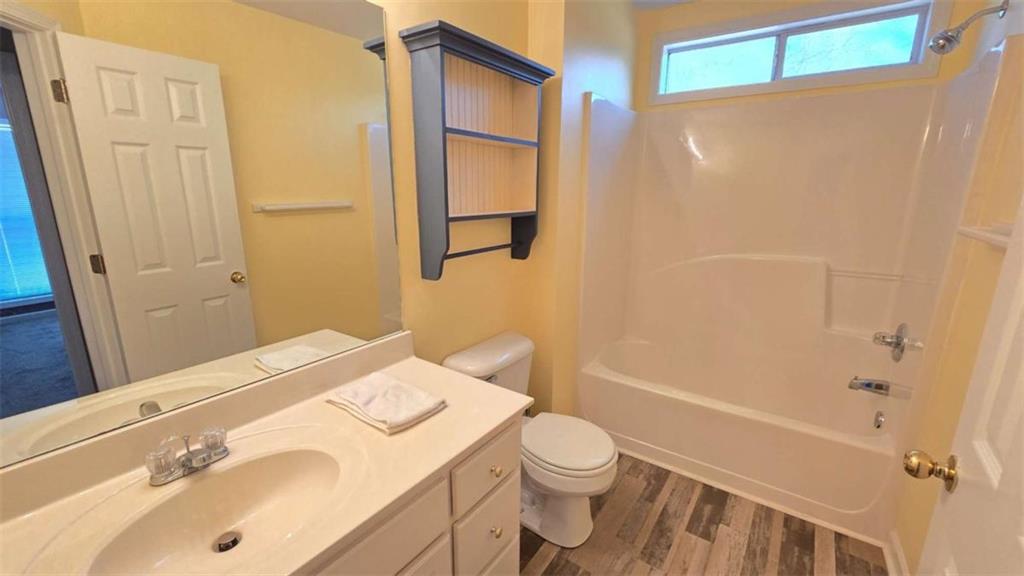 352 Olde Wick Trail Hoschton, GA 30548 - Photo 22 of 34 a bathroom with a sink toilet and shower
