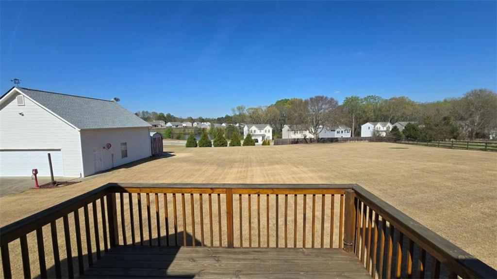 352 Olde Wick Trail Hoschton, GA 30548 - Photo 25 of 34 a balcony with wooden floor and city view