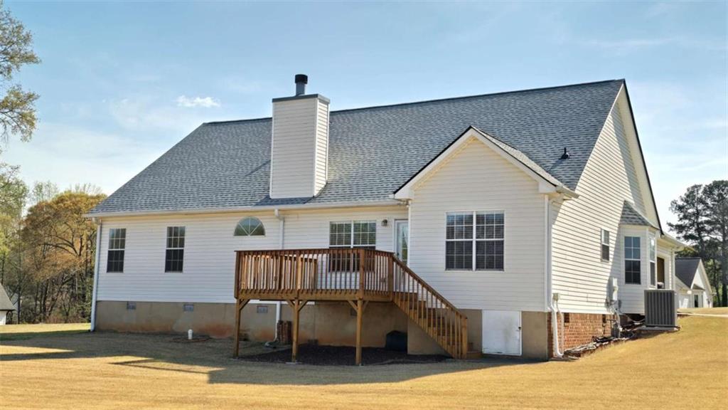 352 Olde Wick Trail Hoschton, GA 30548 - Photo 32 of 34 a view of a house with wooden deck and furniture