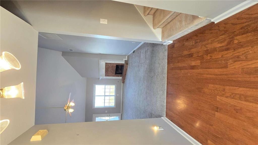 352 Olde Wick Trail Hoschton, GA 30548 - Photo 5 of 34 a view of a hallway with wooden floor