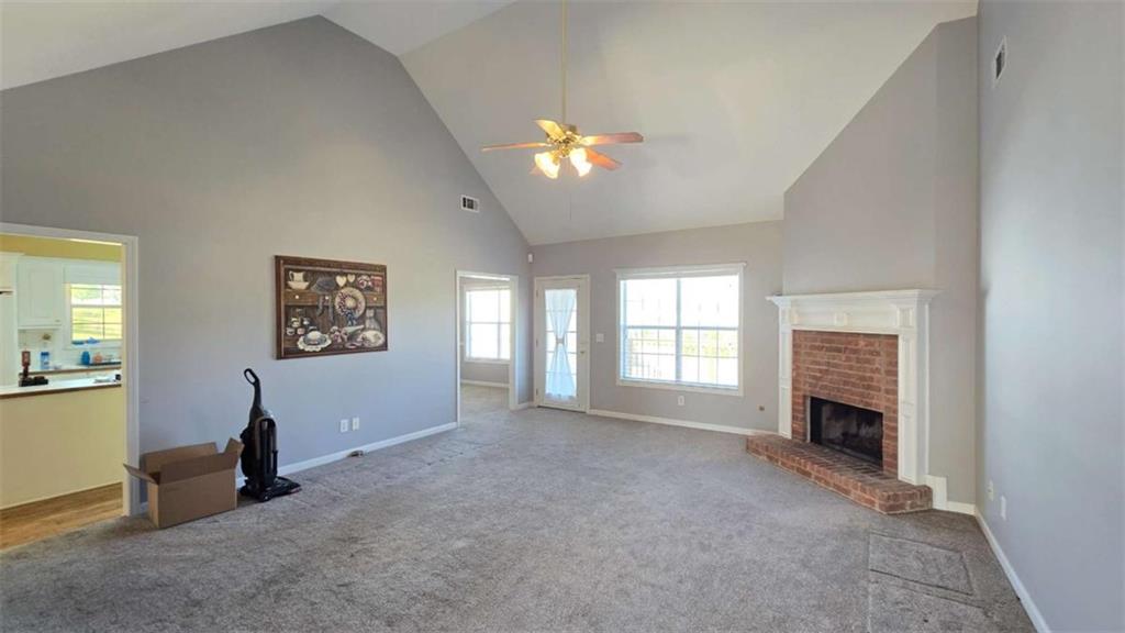 352 Olde Wick Trail Hoschton, GA 30548 - Photo 6 of 34 a view of livingroom with window fireplace and ceiling fan