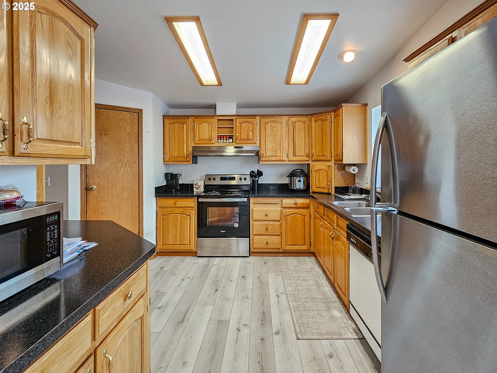 1509 Centennial Circle Forest Grove, OR 97116 - Photo 11 of 45 a kitchen with stainless steel appliances granite countertop sink stove top oven and cabinets