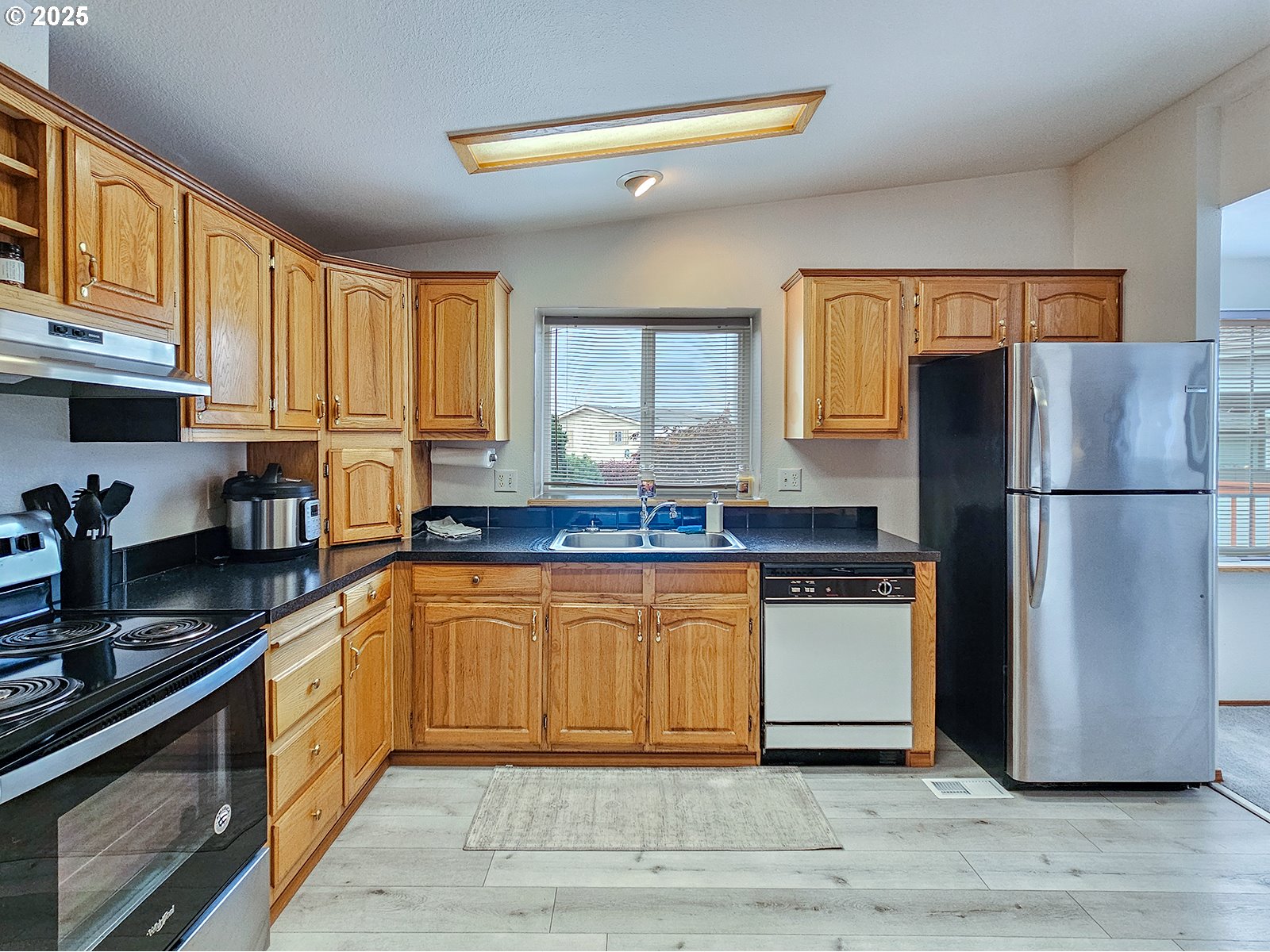 1509 Centennial Circle Forest Grove, OR 97116 - Photo 13 of 45 a kitchen with granite countertop a refrigerator stove top oven and sink