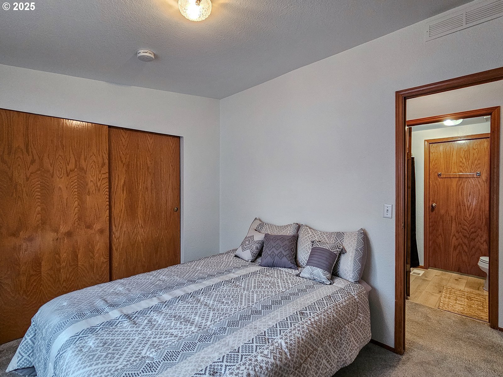 1509 Centennial Circle Forest Grove, OR 97116 - Photo 21 of 45 a bedroom with a bed and a window