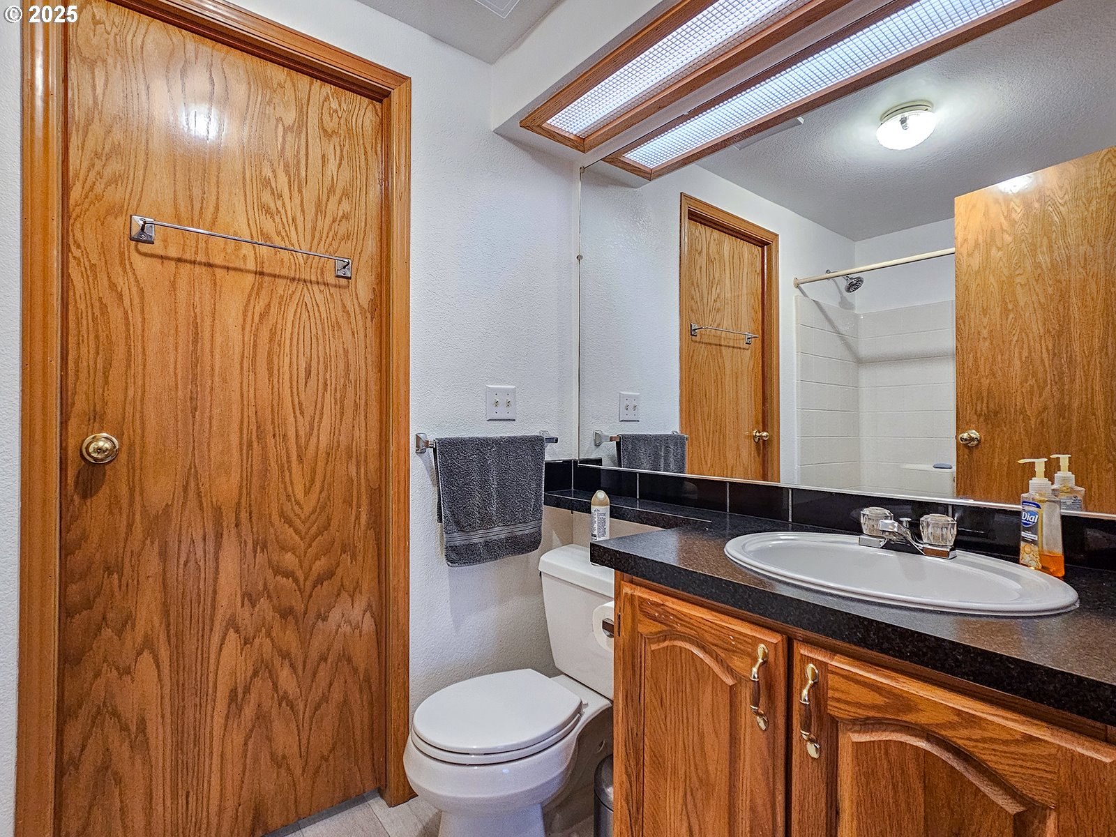 1509 Centennial Circle Forest Grove, OR 97116 - Photo 23 of 45 a bathroom with a granite countertop sink toilet and shower