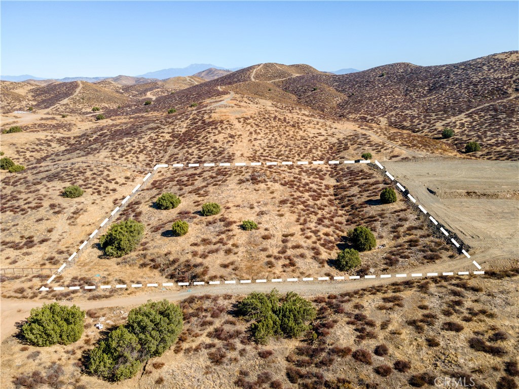 a view of a mountain with a field