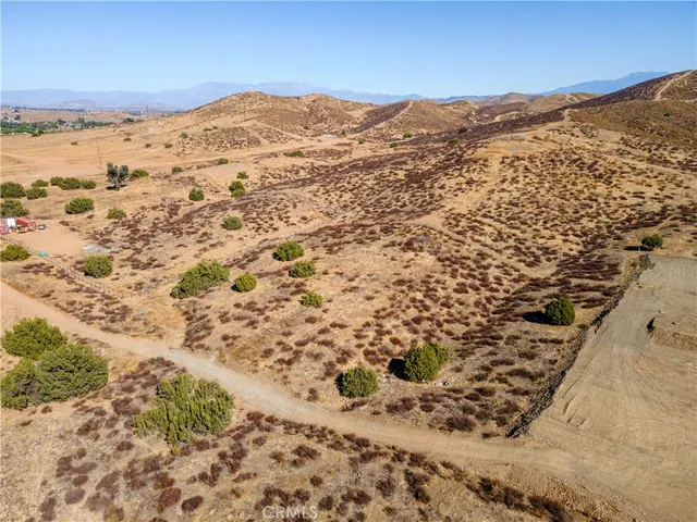 an aerial view of residential house and sandy dunes