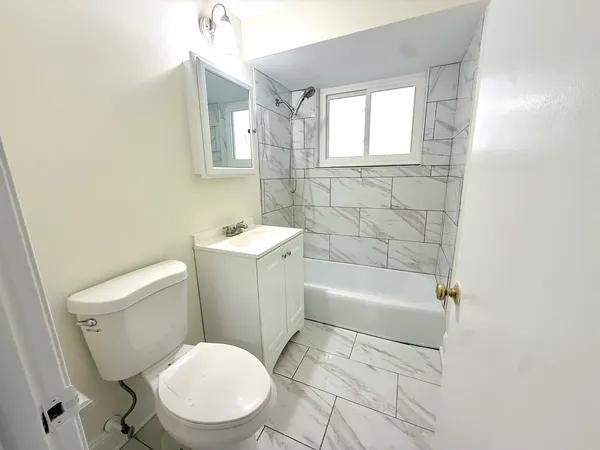 a bathroom with a sink toilet and a mirror