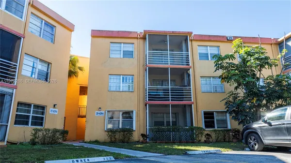 a view of a building in the front of a yard