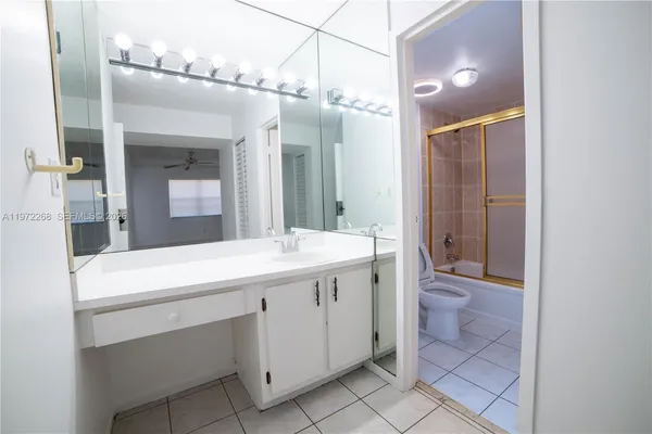 a bathroom with a sink a vanity and a mirror