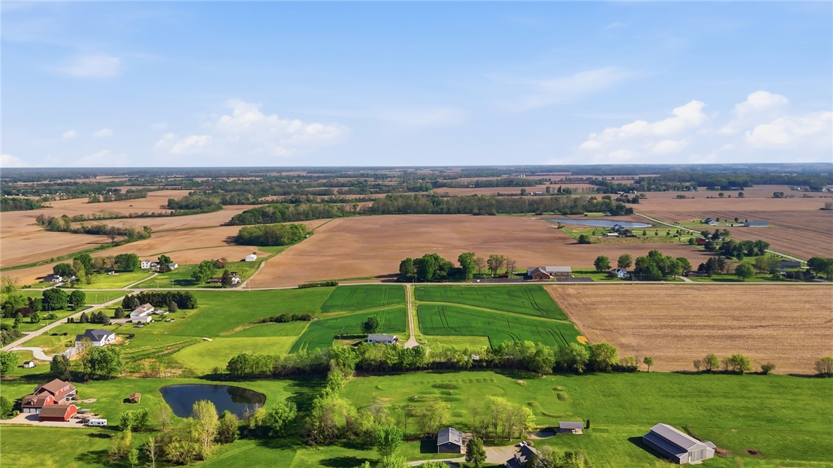 0 East Peterson Road Piqua, OH 45356 - Photo 2 of 7 An aerial view captures the sprawling landscape, showcasing diverse terrains and scattered structures.