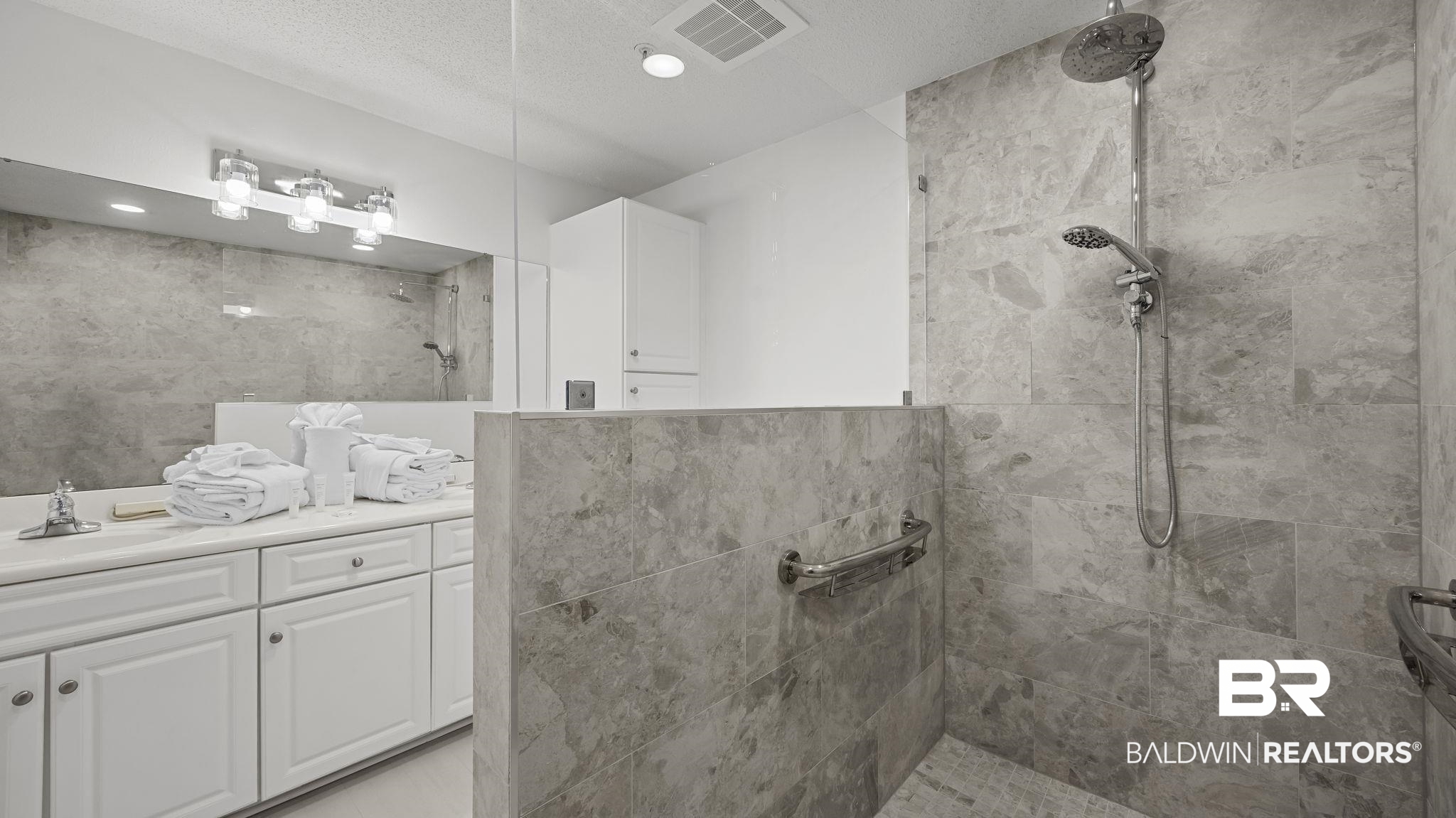 27580 Canal Road, Unit 1213 Orange Beach, AL 36561 - Photo 11 of 27 Spacious walk-in shower with floor-to-ceiling stone-finish tiling and multiple shower heads