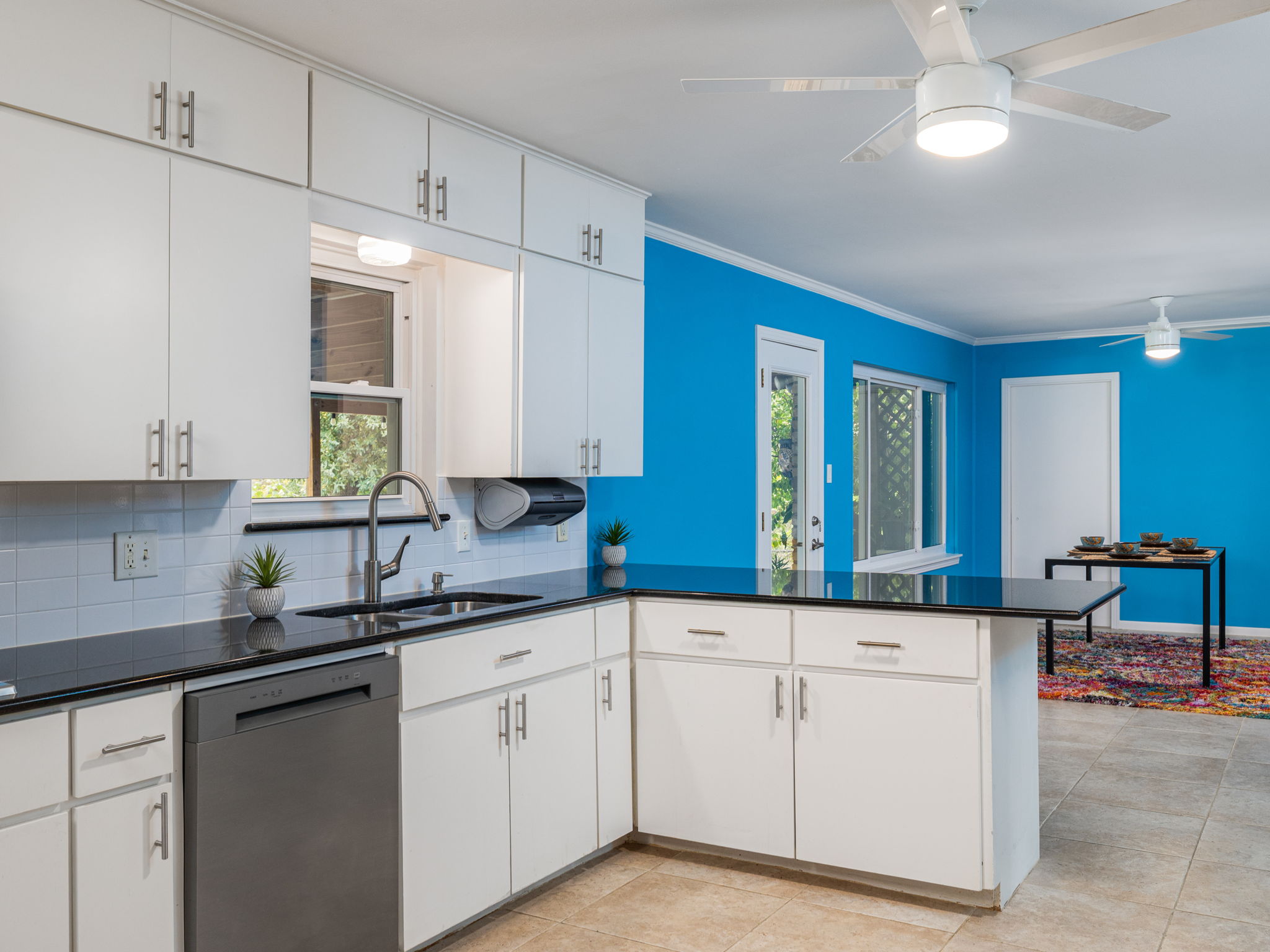 4710 Frontier Trail Austin, TX 78745 - Photo 11 of 32 a kitchen with granite countertop white cabinets and a sink