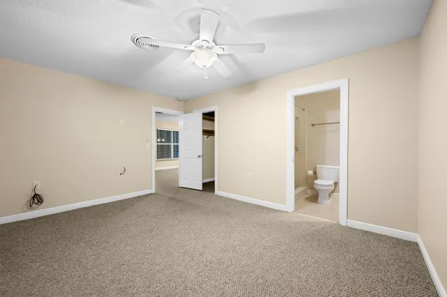 a view of an empty room with a fan