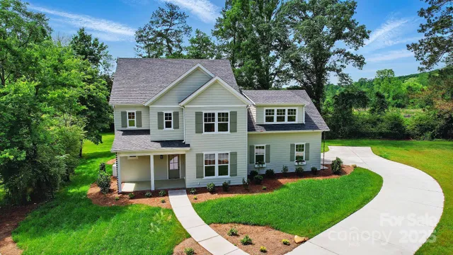 a aerial view of a house with a yard patio and a tree