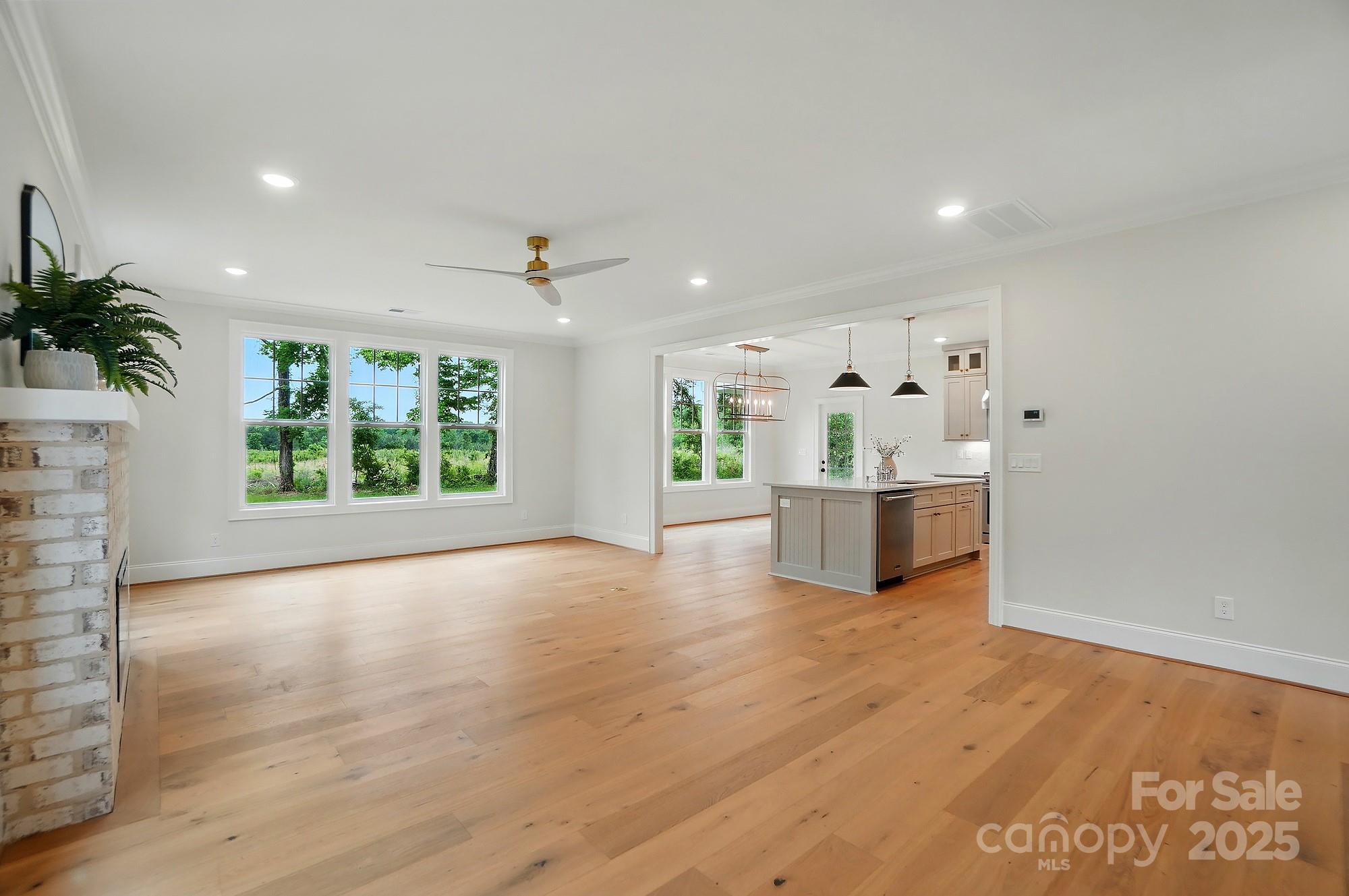 9315 Simpson Road Waxhaw, NC 28173 - Photo 11 of 45 a view of a big room with wooden floor and windows