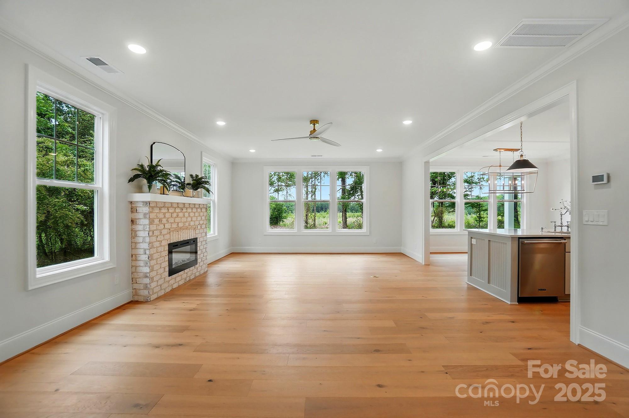 9315 Simpson Road Waxhaw, NC 28173 - Photo 12 of 45 a view of an empty room with a fireplace and a window