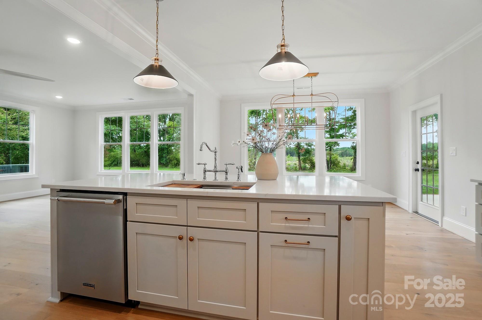 9315 Simpson Road Waxhaw, NC 28173 - Photo 14 of 45 a kitchen with white cabinets and window