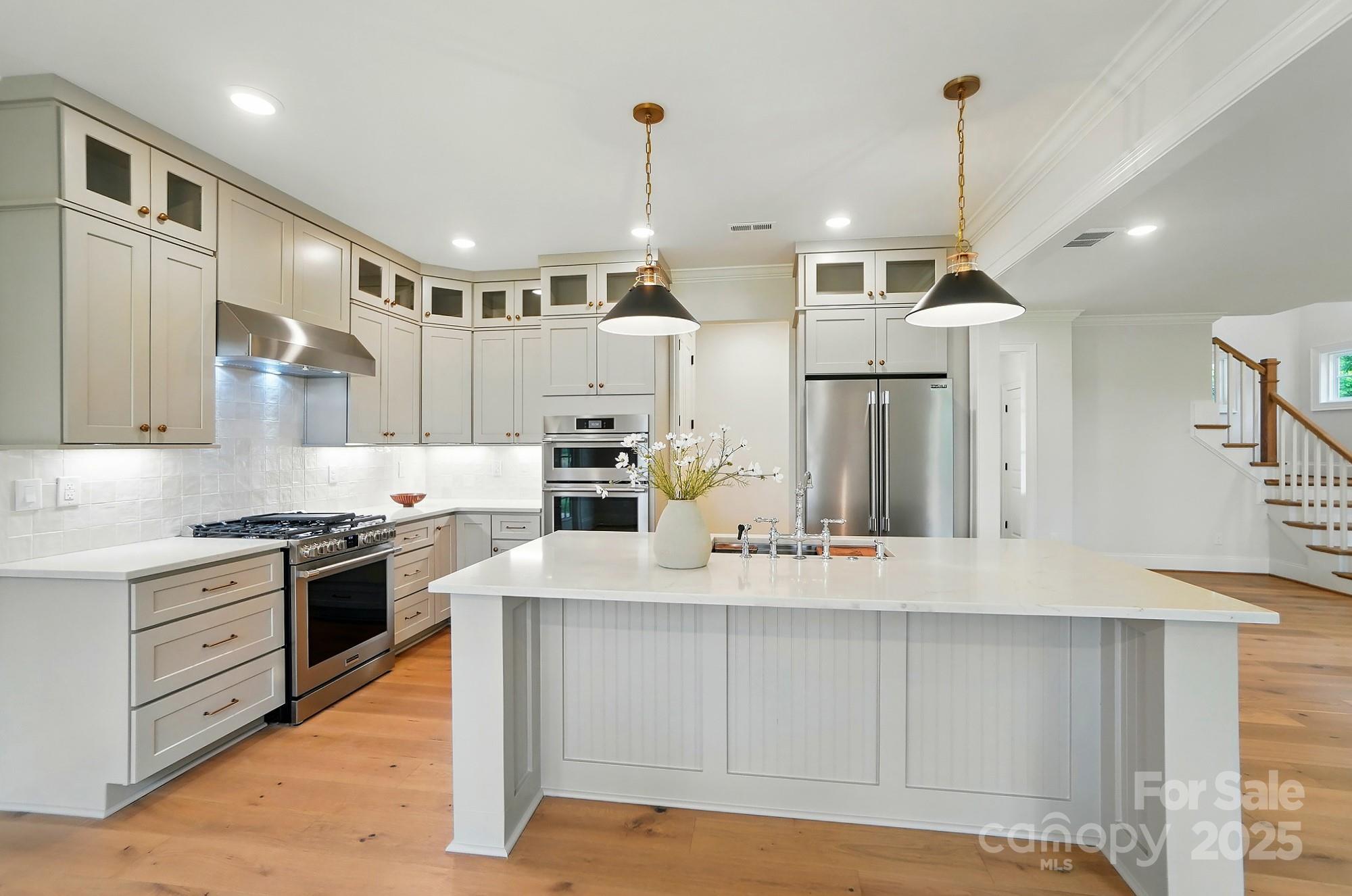 9315 Simpson Road Waxhaw, NC 28173 - Photo 16 of 45 a kitchen with stainless steel appliances granite countertop a sink a stove and a refrigerator