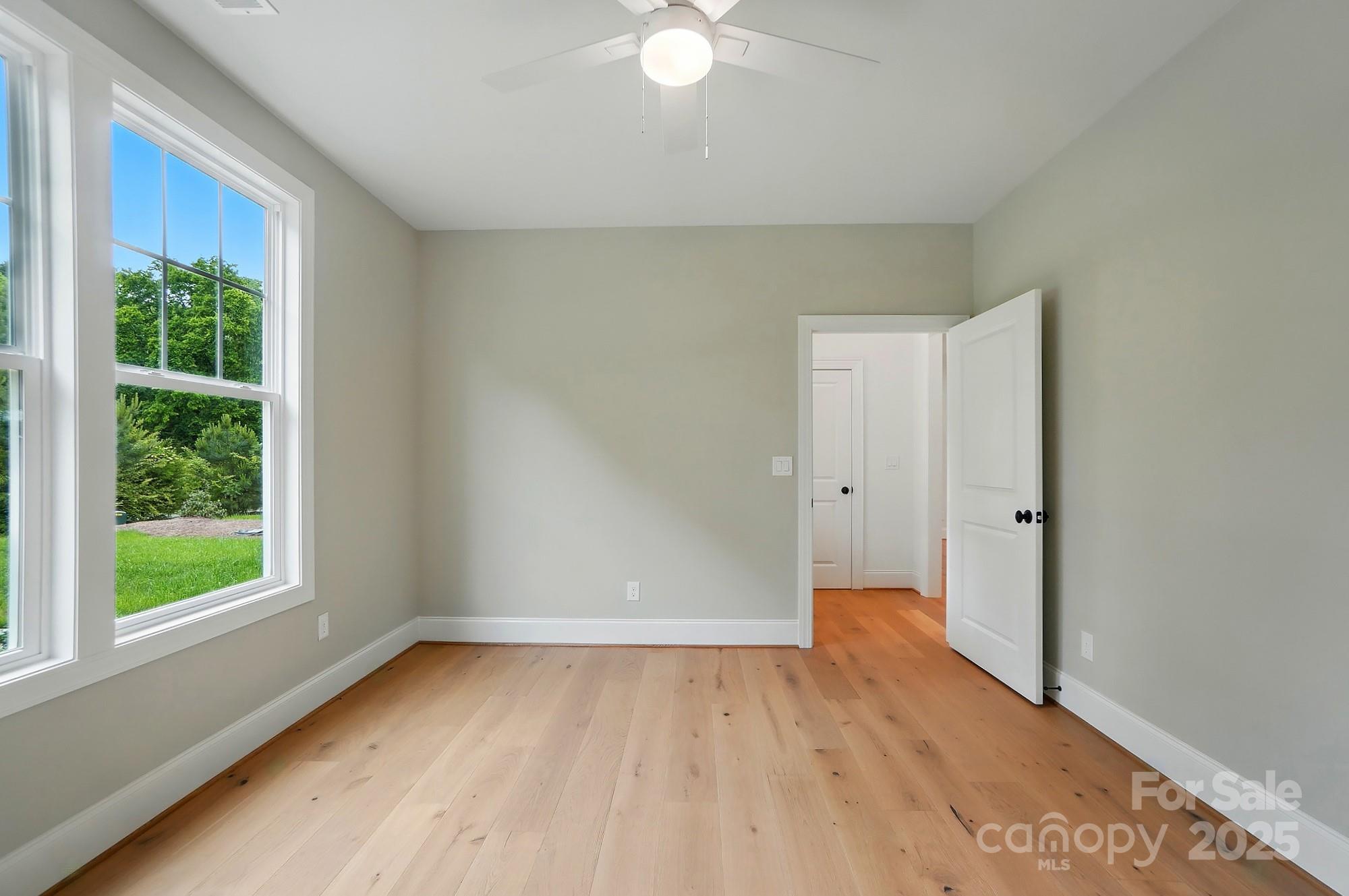 9315 Simpson Road Waxhaw, NC 28173 - Photo 21 of 45 a view of an empty room with wooden floor and a window