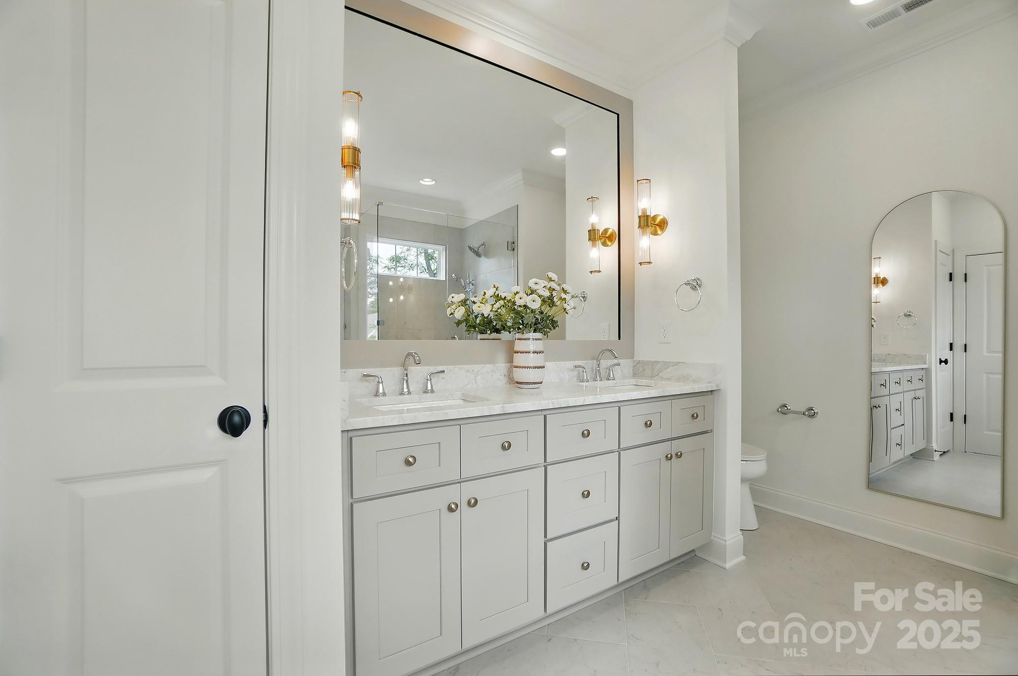 9315 Simpson Road Waxhaw, NC 28173 - Photo 25 of 45 a bathroom with a granite countertop sink mirror and shower