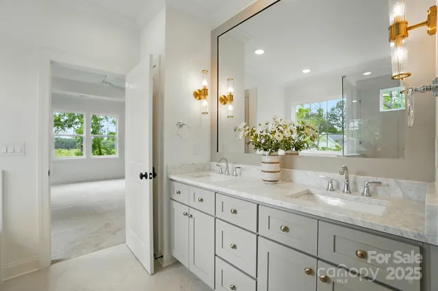 a bathroom with a granite countertop sink a mirror and a shower